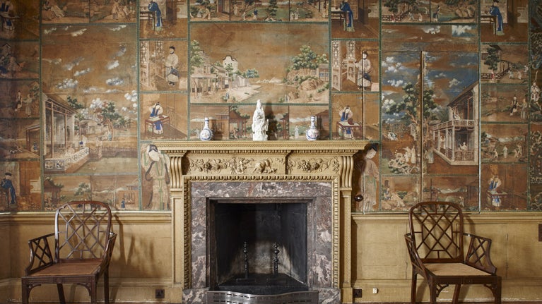 The fireplace in the study at Saltram, Devon, surrounded by Chinese wallpaper